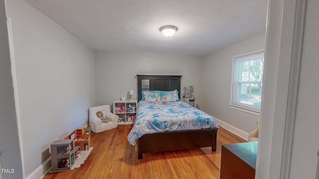 bedroom with wood-type flooring