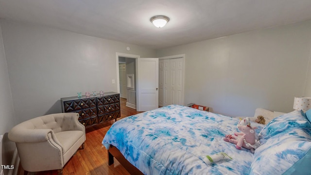 bedroom with a closet and dark wood-type flooring