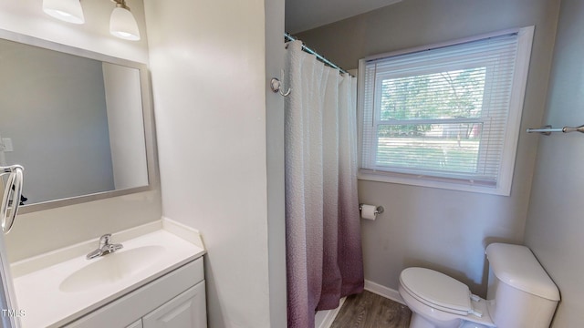 bathroom featuring hardwood / wood-style floors, toilet, vanity, and a shower with shower curtain