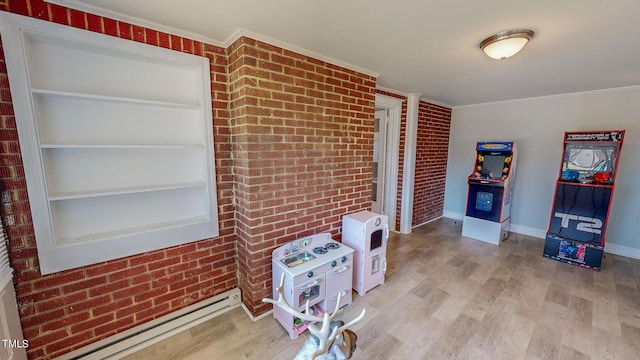 interior space featuring a baseboard radiator, light hardwood / wood-style flooring, heating unit, brick wall, and ornamental molding