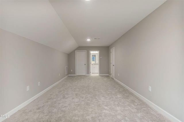 3097 Banks School Rd, Kinston, NC 28504 - additional living space with baseboards, light colored carpet, and vaulted ceiling