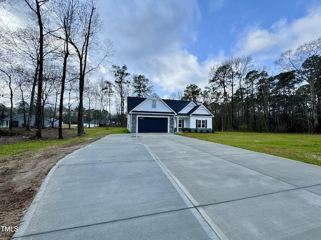 3097 Banks School Rd, Kinston, NC 28504 - view of front of property featuring an attached garage, concrete driveway, stone siding, and a front yard