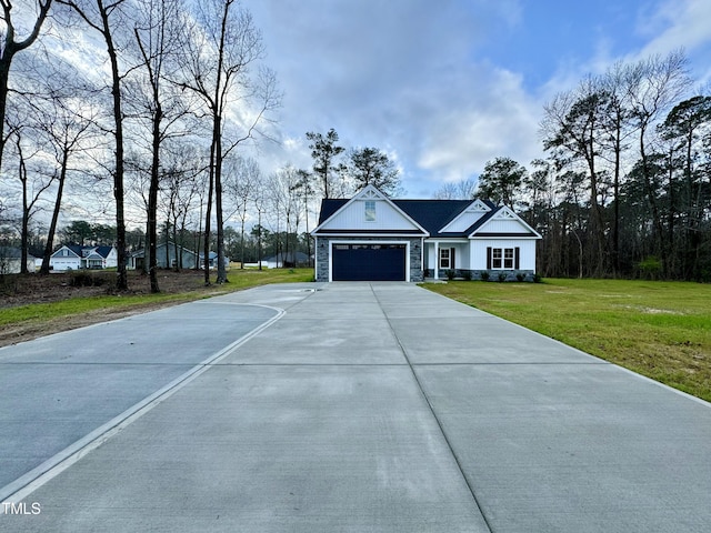 3097 Banks School Rd, Kinston, NC 28504 - view of front of property featuring concrete driveway, a garage, stone siding, and a front yard