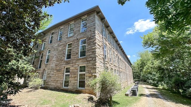 rear view of house with central AC and a yard