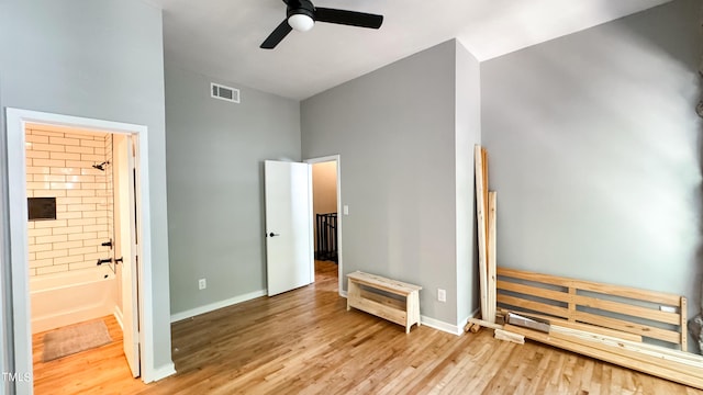 bedroom featuring ensuite bath and light hardwood / wood-style floors
