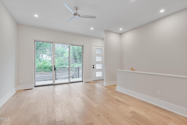 spare room featuring light hardwood / wood-style flooring and ceiling fan