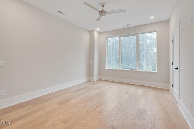 unfurnished room with ceiling fan and light hardwood / wood-style floors