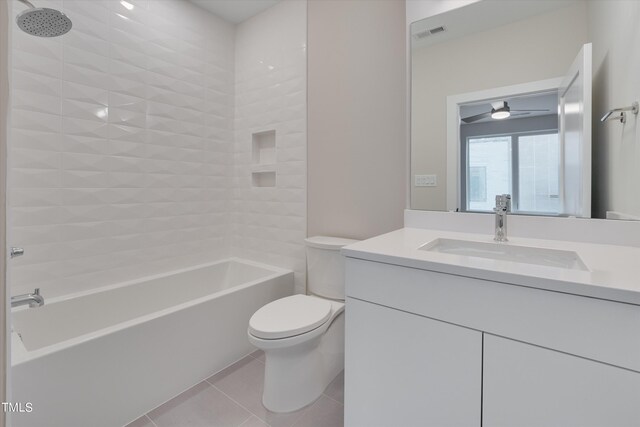 full bathroom featuring vanity, toilet, tile patterned floors, and tiled shower / bath