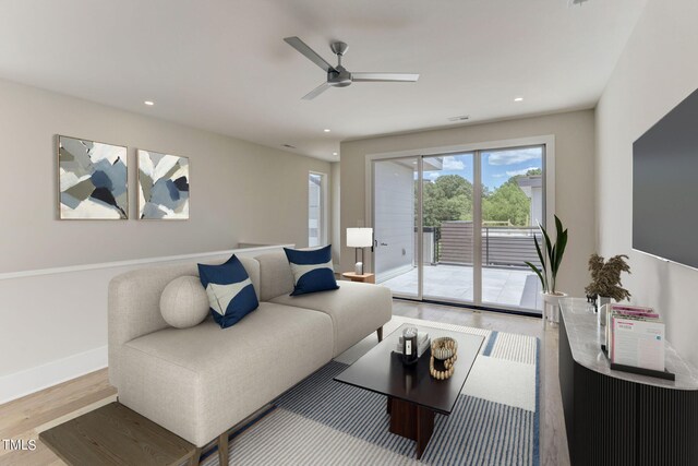 living room featuring hardwood / wood-style flooring and ceiling fan