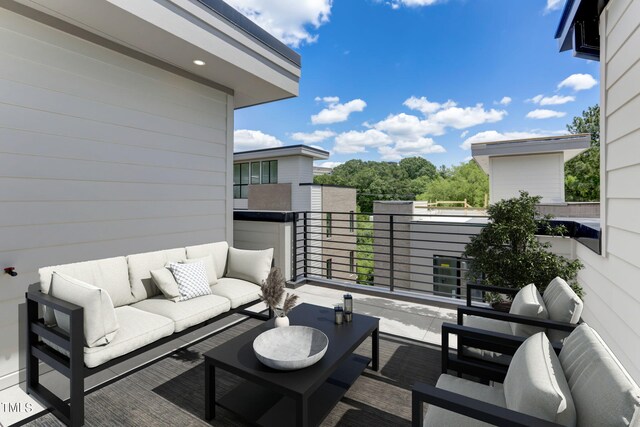 exterior space featuring an outdoor hangout area and a balcony