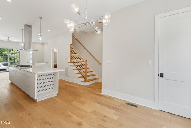 interior space featuring a notable chandelier and light wood-type flooring