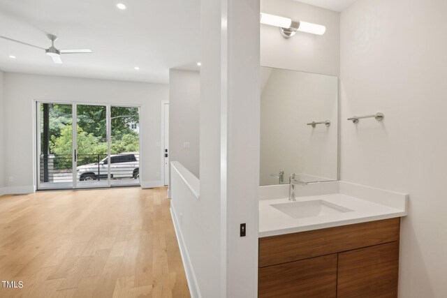 bathroom with vanity, ceiling fan, and hardwood / wood-style floors