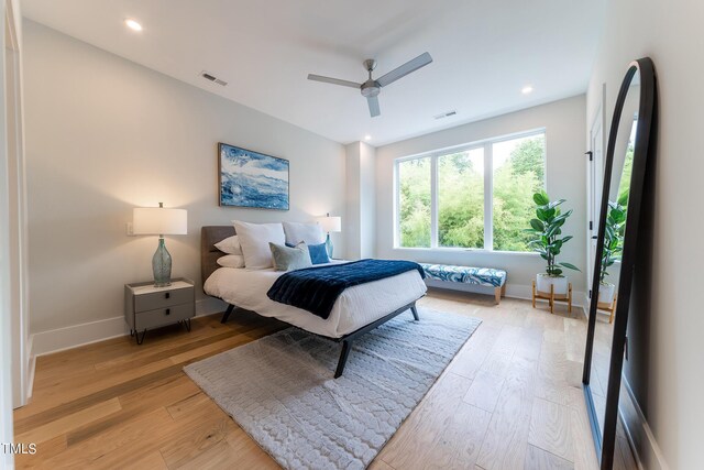 bedroom with light hardwood / wood-style flooring and ceiling fan