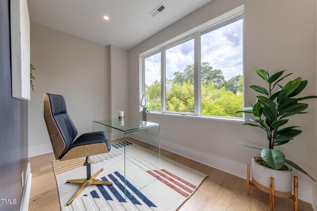 office area with plenty of natural light and wood-type flooring