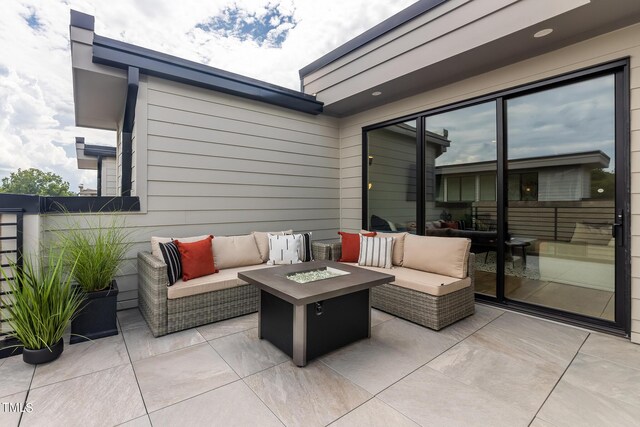 view of patio featuring an outdoor living space with a fire pit