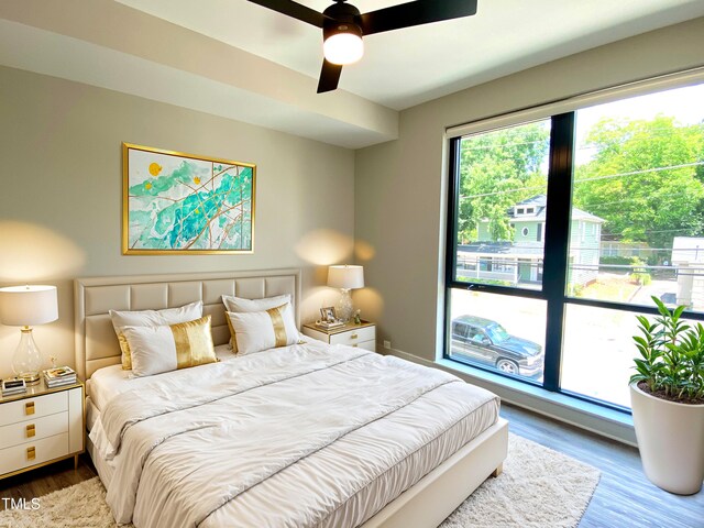 bedroom with hardwood / wood-style floors and ceiling fan