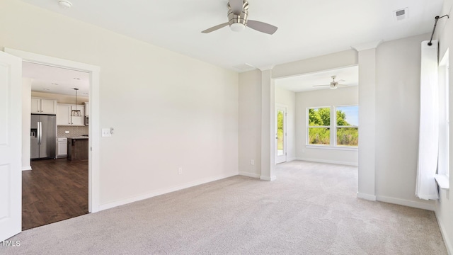 carpeted empty room featuring ceiling fan