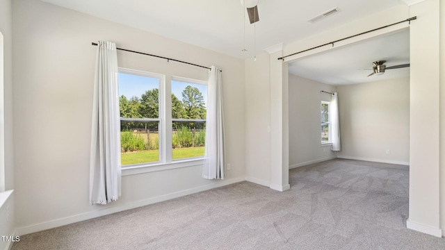 empty room with light carpet and ceiling fan