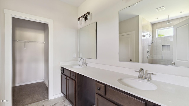 bathroom with tile patterned floors, vanity, and a shower with door