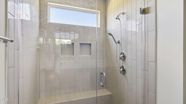 bathroom with a shower with door