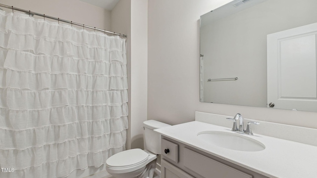 bathroom featuring a shower with curtain, vanity, and toilet