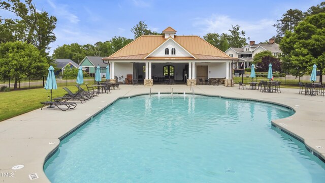 view of pool featuring a yard and a patio area