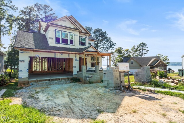 view of front facade with a water view and covered porch