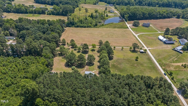 birds eye view of property featuring a water view and a rural view