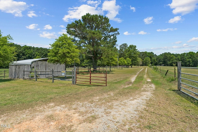 view of yard featuring a rural view and an outdoor structure