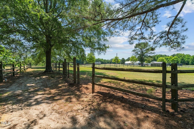 view of gate with a rural view