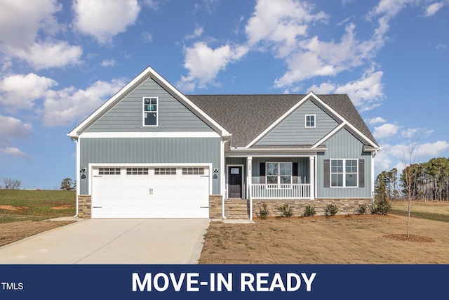 craftsman house featuring covered porch and a garage