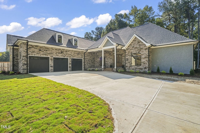 view of front of home with a front lawn and a garage