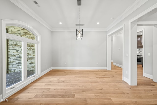 unfurnished dining area with light wood-type flooring, ornamental molding, and a healthy amount of sunlight