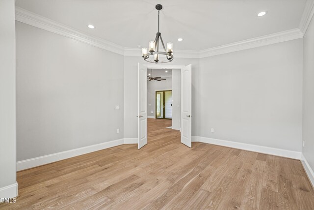 spare room with ceiling fan with notable chandelier, light hardwood / wood-style flooring, and ornamental molding