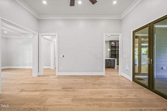 spare room featuring ornamental molding, ceiling fan, and light hardwood / wood-style flooring