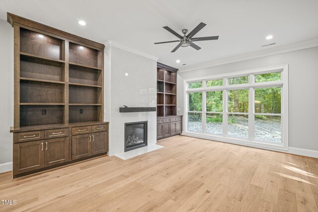 unfurnished living room featuring ornamental molding, light hardwood / wood-style floors, and ceiling fan