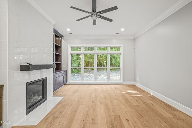 unfurnished living room with ceiling fan, light hardwood / wood-style flooring, and ornamental molding