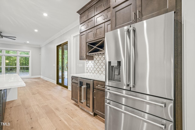 kitchen with wine cooler, stainless steel refrigerator with ice dispenser, light hardwood / wood-style flooring, and a wealth of natural light