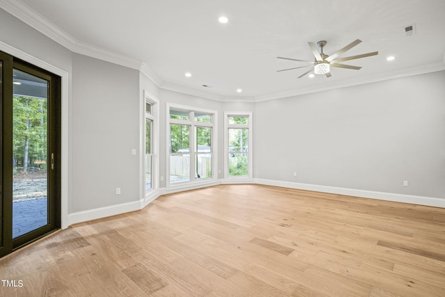 spare room with ornamental molding, light hardwood / wood-style floors, and a healthy amount of sunlight