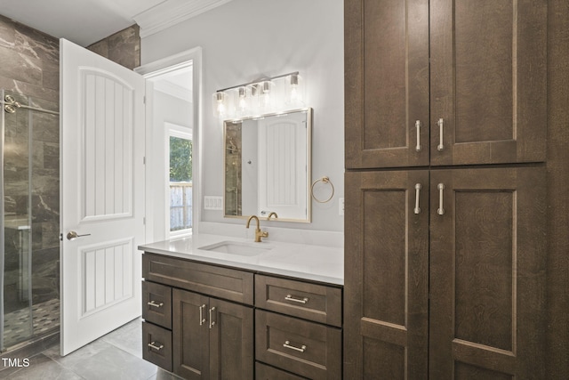 bathroom with a shower with shower door, ornamental molding, vanity, and tile patterned floors