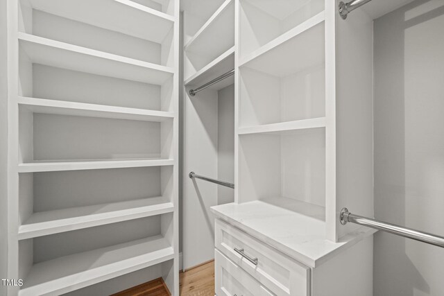 spacious closet featuring hardwood / wood-style floors