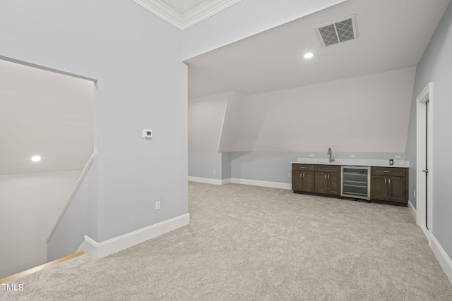 bar featuring light carpet, beverage cooler, sink, and ornamental molding