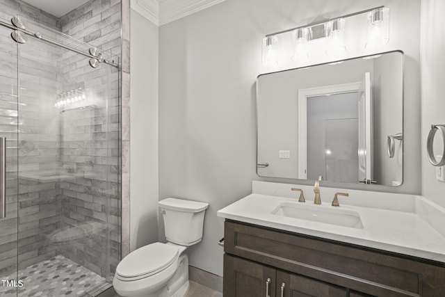 bathroom with crown molding, vanity, toilet, and a shower with shower door