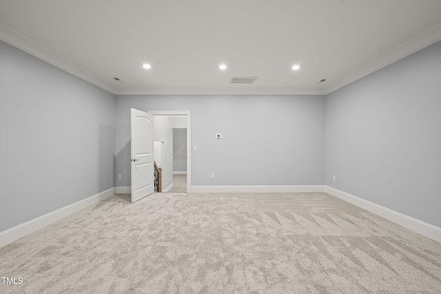 carpeted empty room featuring crown molding