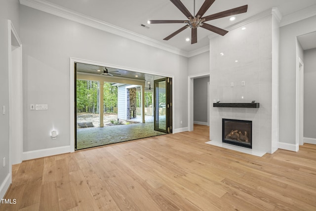 unfurnished living room with light wood-type flooring, a fireplace, ornamental molding, and ceiling fan