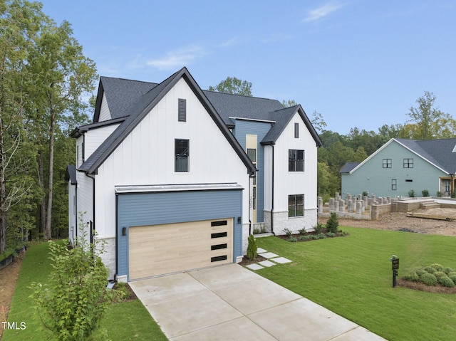 modern farmhouse featuring a front yard and a garage