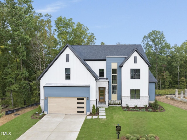 modern inspired farmhouse with a garage and a front yard