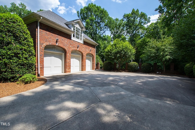 1820 Oatlands Ct, Wake Forest, NC 27587 - view of property exterior with concrete driveway, brick siding, and a shingled roof
