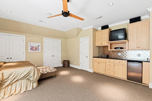 interior space with refrigerator, ceiling fan, crown molding, sink, and multiple closets