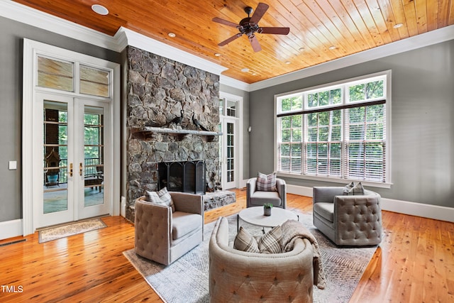 living room featuring ceiling fan, french doors, wooden ceiling, hardwood / wood-style floors, and a fireplace